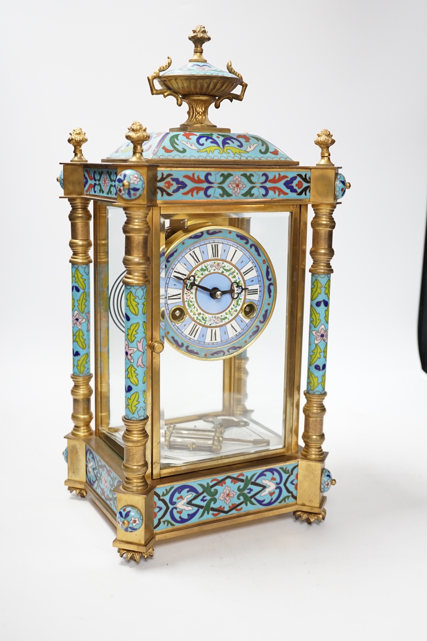 A champlevé four glass and brass mantel clock, with enamel dial, 45cm high